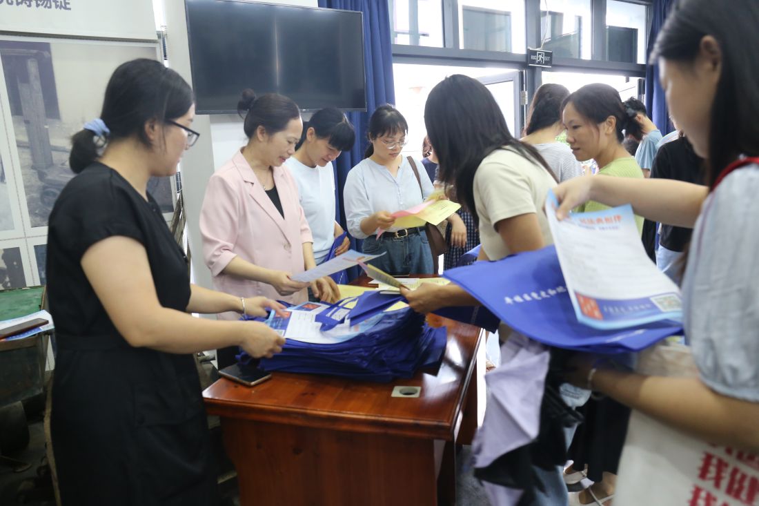 图为档案馆工作人员正在发放宣传资料、提供咨询服务.jpg