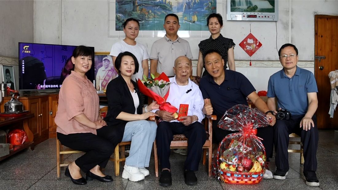 桂林市档案馆馆长李南海(右)坐在抗战老兵张建华(左)身旁，轻声交流.jpg