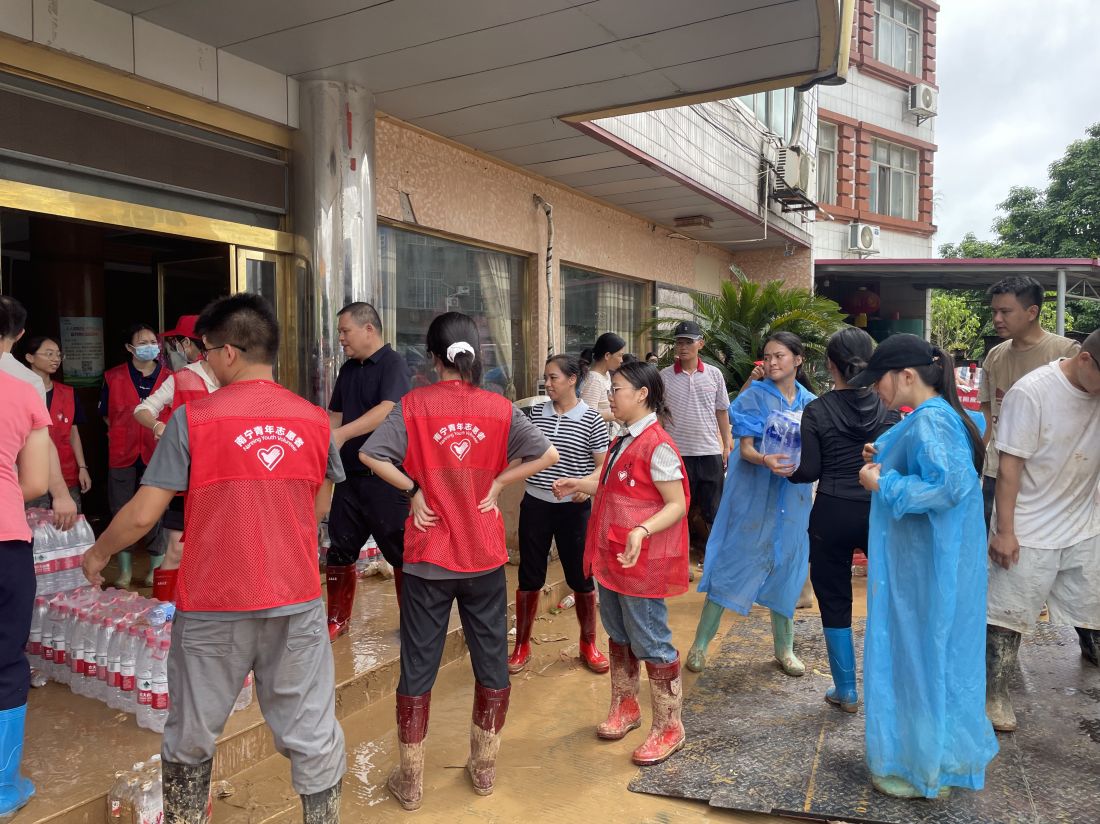 图为宾阳县国家档案馆党员干部在甘棠镇物资集中发放点搬运、分发救灾物资.jpg